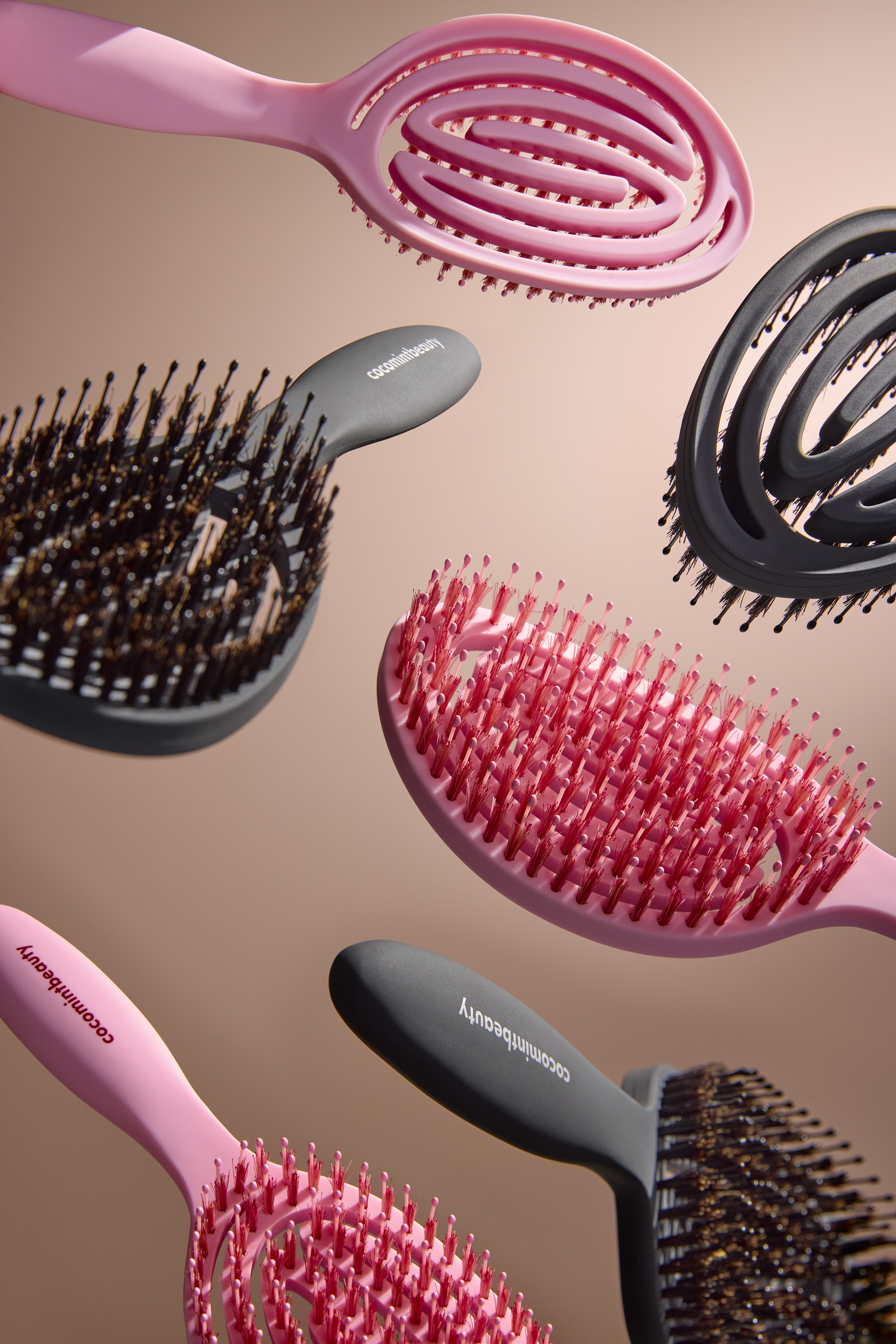 Collection of hairbrushes with different designs on a beige background