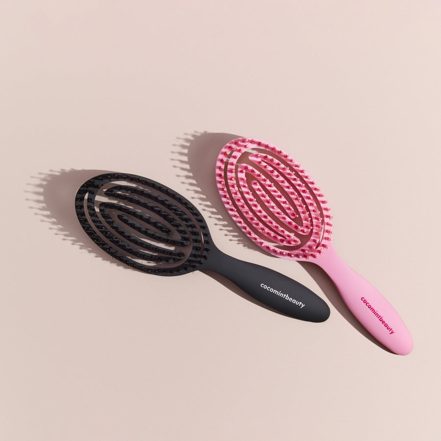 Black and pink hairbrushes with 'cocomintbeauty' branding on a beige background