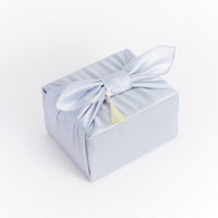 Light blue gift box with a bow on a white background
