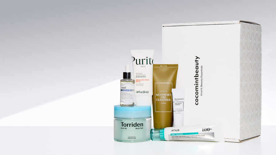 Collection of skincare products and packaging on a light gray background