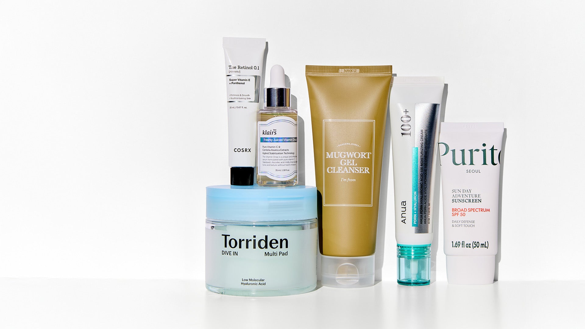 Collection of skincare products from different brands on a white background