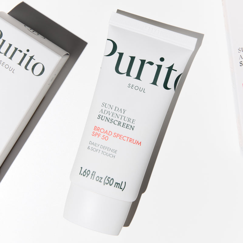 Two tubes of Purito Sun Day Adventure Sunscreen on a white background