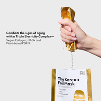 Hand squeezing serum from the Cocomint Beauty collagen face mask (Korean) containing NAD+ and PDRN for anti-aging