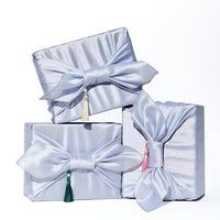 Premium Korean skincare gift set by Cocomint Beauty, wrapped in traditional blue Bojagi silk cloth with tassels. The ultimate K-beauty unboxing experience for gifting.