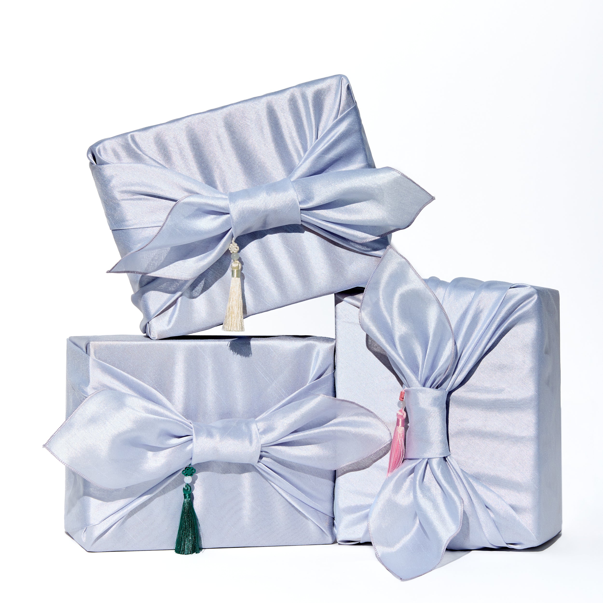 Premium Korean skincare gift set by Cocomint Beauty, wrapped in traditional blue Bojagi silk cloth with tassels. The ultimate K-beauty unboxing experience for gifting.